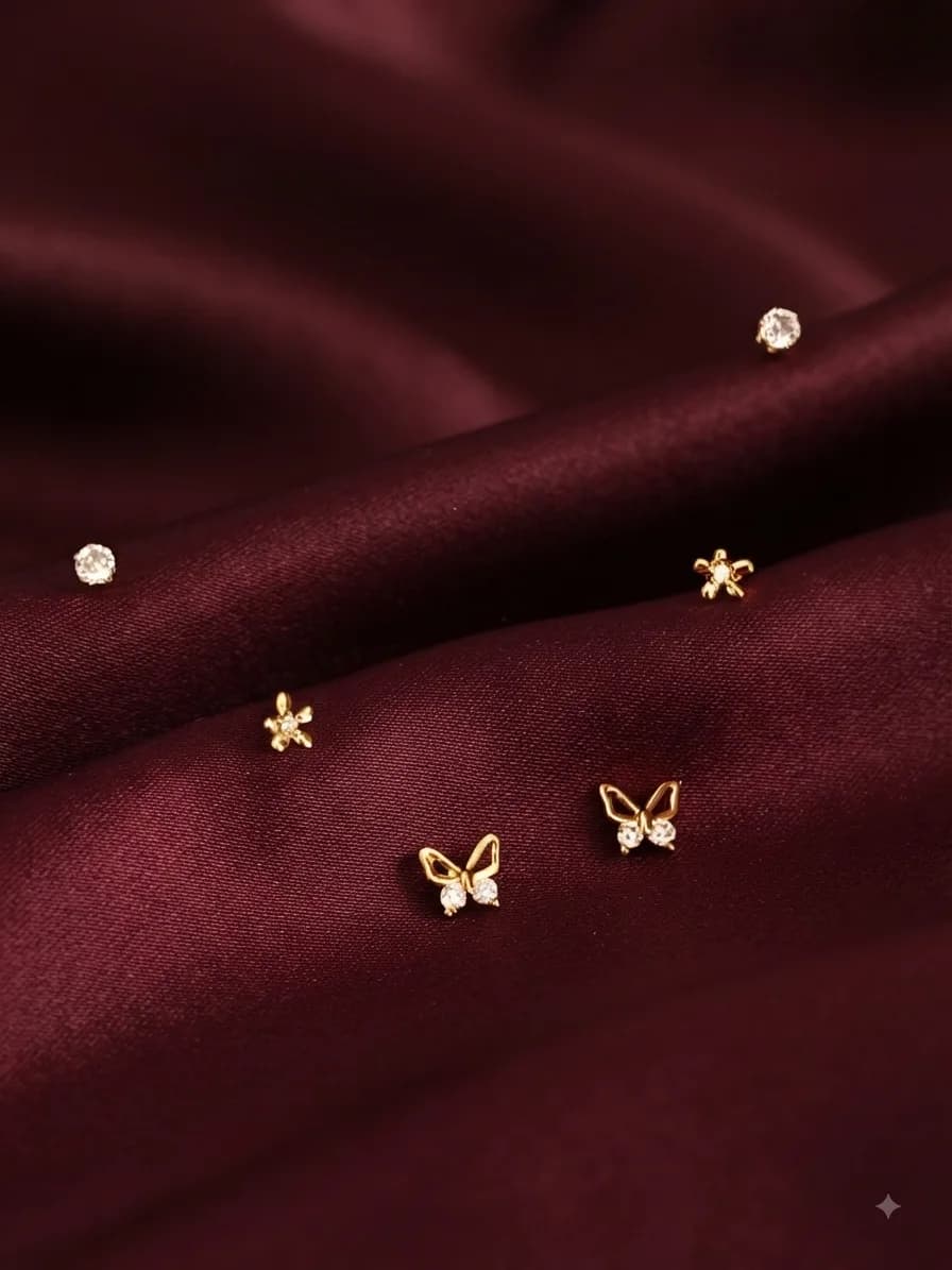 A Celeste gold-plated studs, on ivory satin