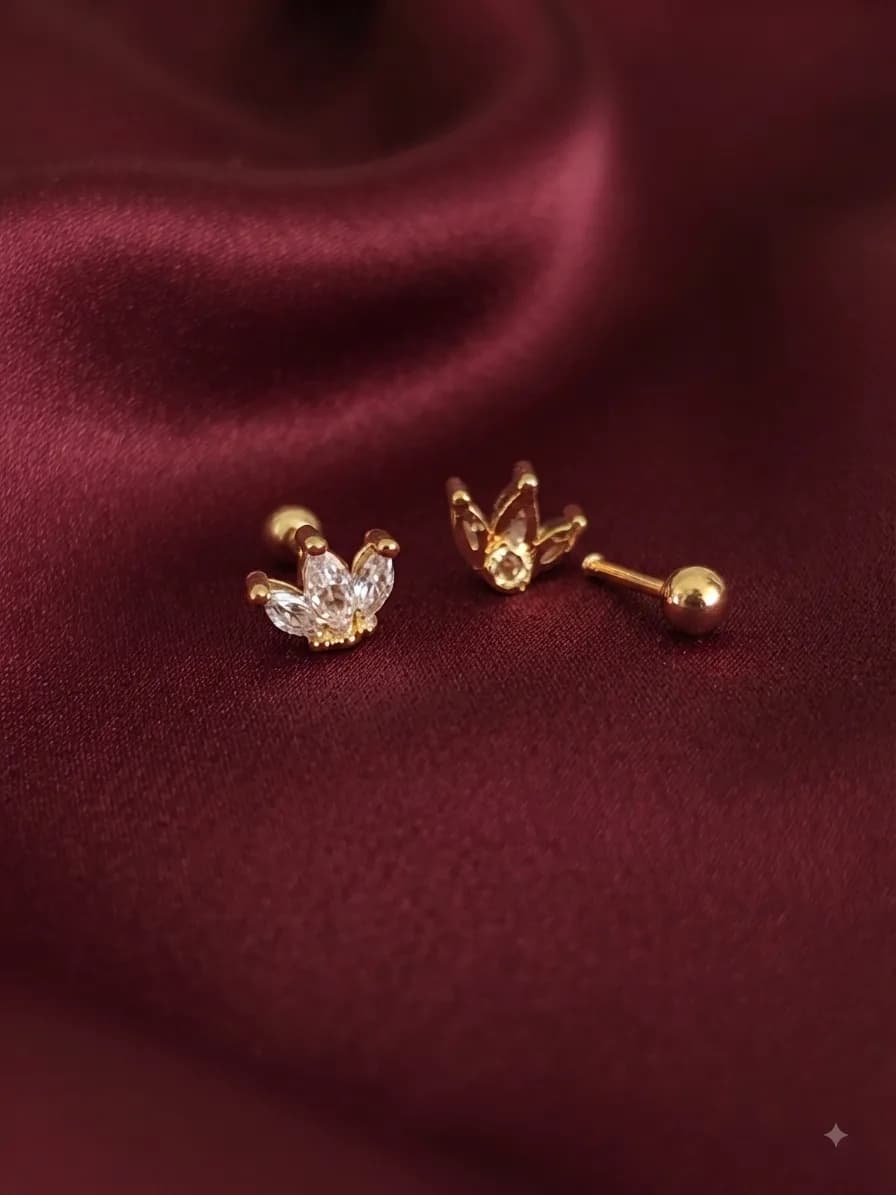 A gold-plated Evara Stud, on ivory satin